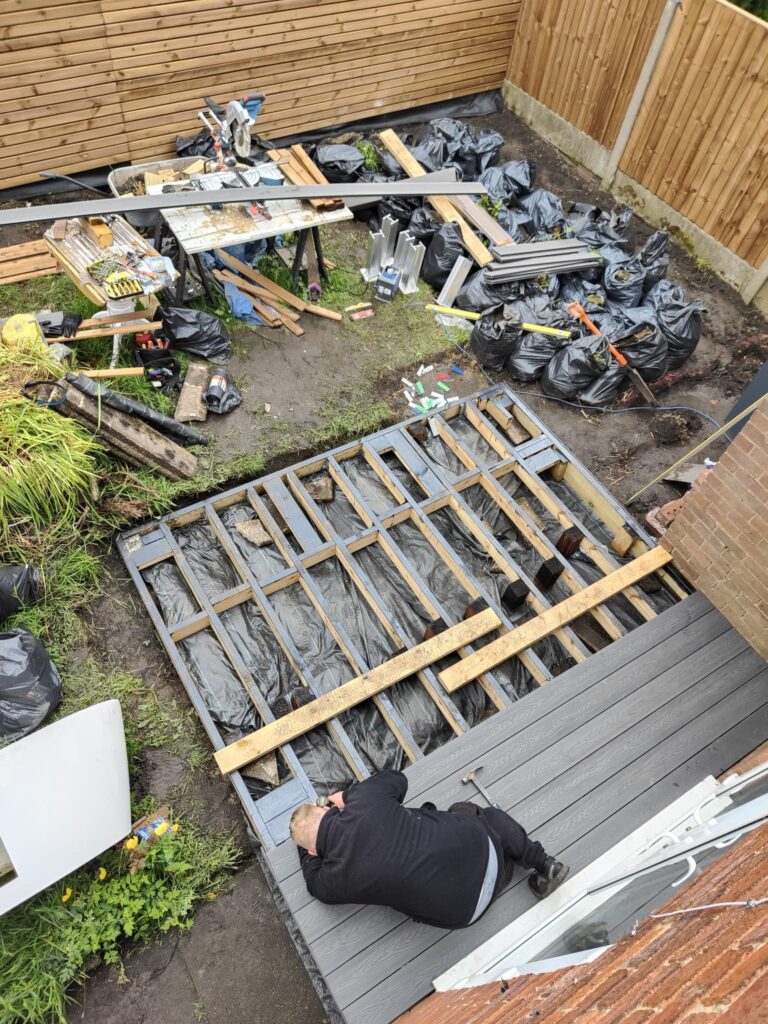 Wolsten installer fitting composite decking boards with hidden clips, Bolton