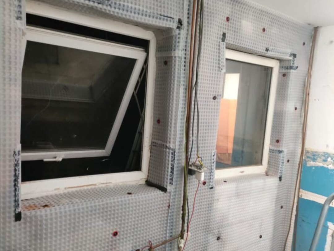 Damp proofing in Bolton — damp-proof membrane sealed around the windows
